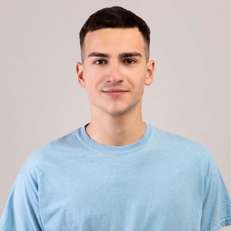 portrait-of-positive-young-guy-in-t-shirt-looking-GKPQ7BL